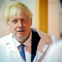 British Prime Minister Boris Johnson visits the Francis Crick Institute in London on Monday. | POOL / VIA REUTERS