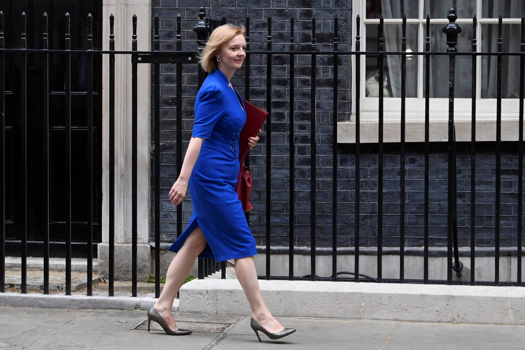 British Foreign Secretary Liz Truss walks outside Downing Street in London on Tuesday. | REUTERS