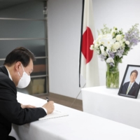 South Korea\'s President Yoon Suk-yeol leaves a condolence message as he mourns at a memorial altar for Japan\'s late former Prime Minister Shinzo Abe, in Seoul, on Tuesday.   | YONHAP / VIA REUTERS  