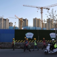 A construction site near residential buildings in Beijing in April. Across China, homebuyers are refusing to pay mortgages as property developers drag on construction projects, escalating the country’s real estate crisis and risks of bad debt for banks.  | REUTERS
