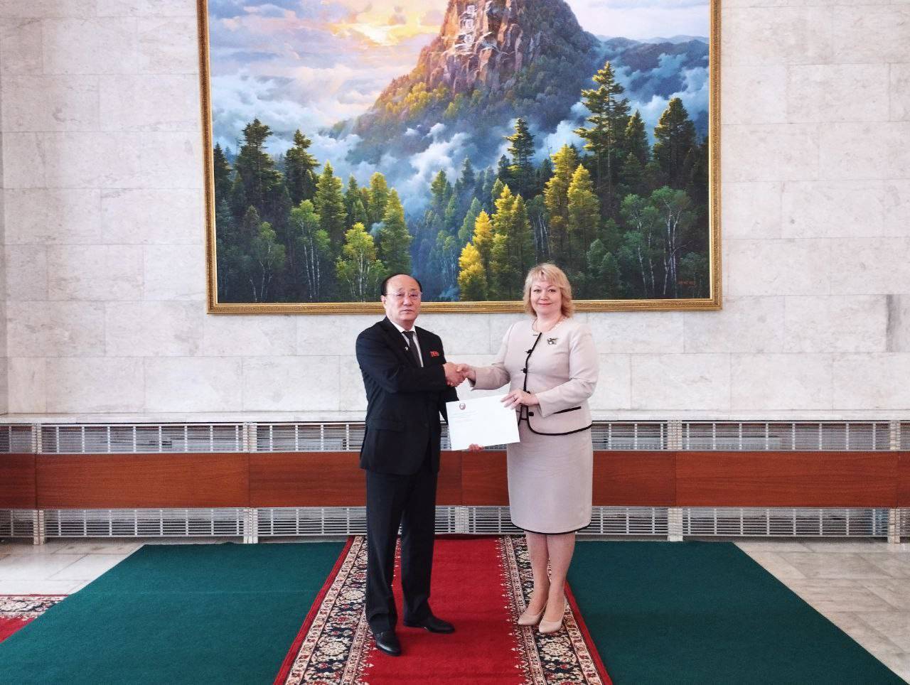 The Donetsk People's Republic Ambassador to Russia Olga Makeyeva receiving a letter of recognition from North Korea's Ambassador to Russia Sin Hong Chol at the Donetsk People's Republic Embassy in Moscow on Wednesday. | EMBASSY OF THE SELF-PROCLAIMED DONETSK PEOPLE'S REPUBLIC / VIA AFP