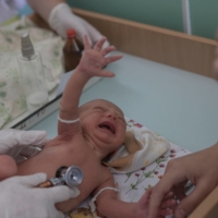 Marina Tupata watches as her baby Sofia is examined inside Pokrovsk maternity hospital on June 29. The Pokrovsk facility now serves the remaining population of the Ukraine-controlled Donetsk region, about 340,000 people, according to the regional governor.  | REUTERS