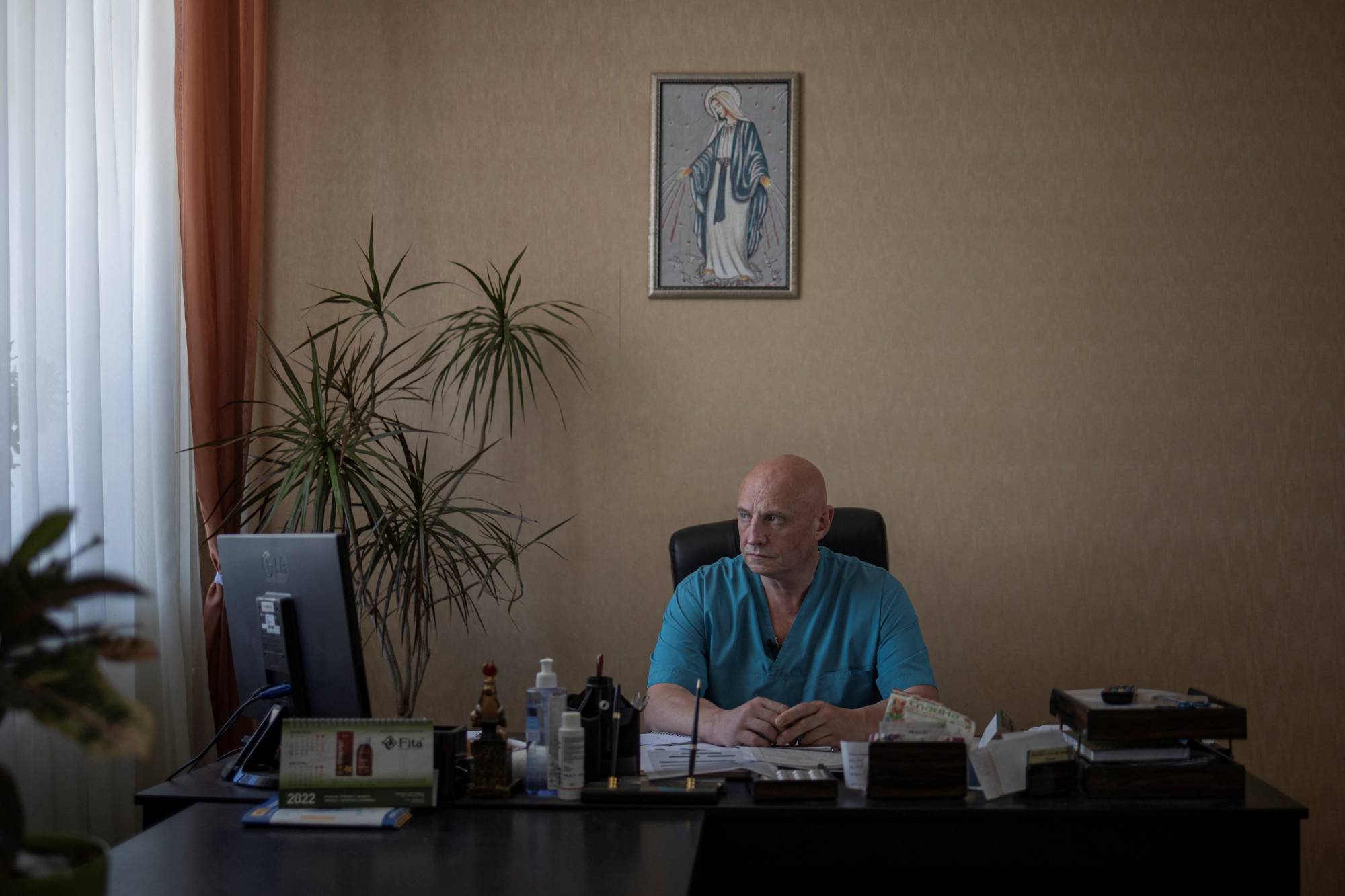 Doctor Ivan Tsyganok, 56, sits at his desk inside Pokrovsk maternity hospital on June 28. | REUTERS