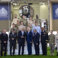 U.S. President Joe Biden (center) is flanked by Israeli Defense Minister Benny Gantz (left) and Prime Minister Yair Lapid as he views a prototype of Iron Beam, Israel\'s new laser defense system, at Ben Gurion International Airport near Jerusalem on Wednesday. | DOUG MILLS / THE NEW YORK TIMES