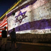 The Israeli and U.S. flags are projected against the wall of the old city of Jerusalem during the visit of the U.S. president on Wednesday. | AFP-JIJI