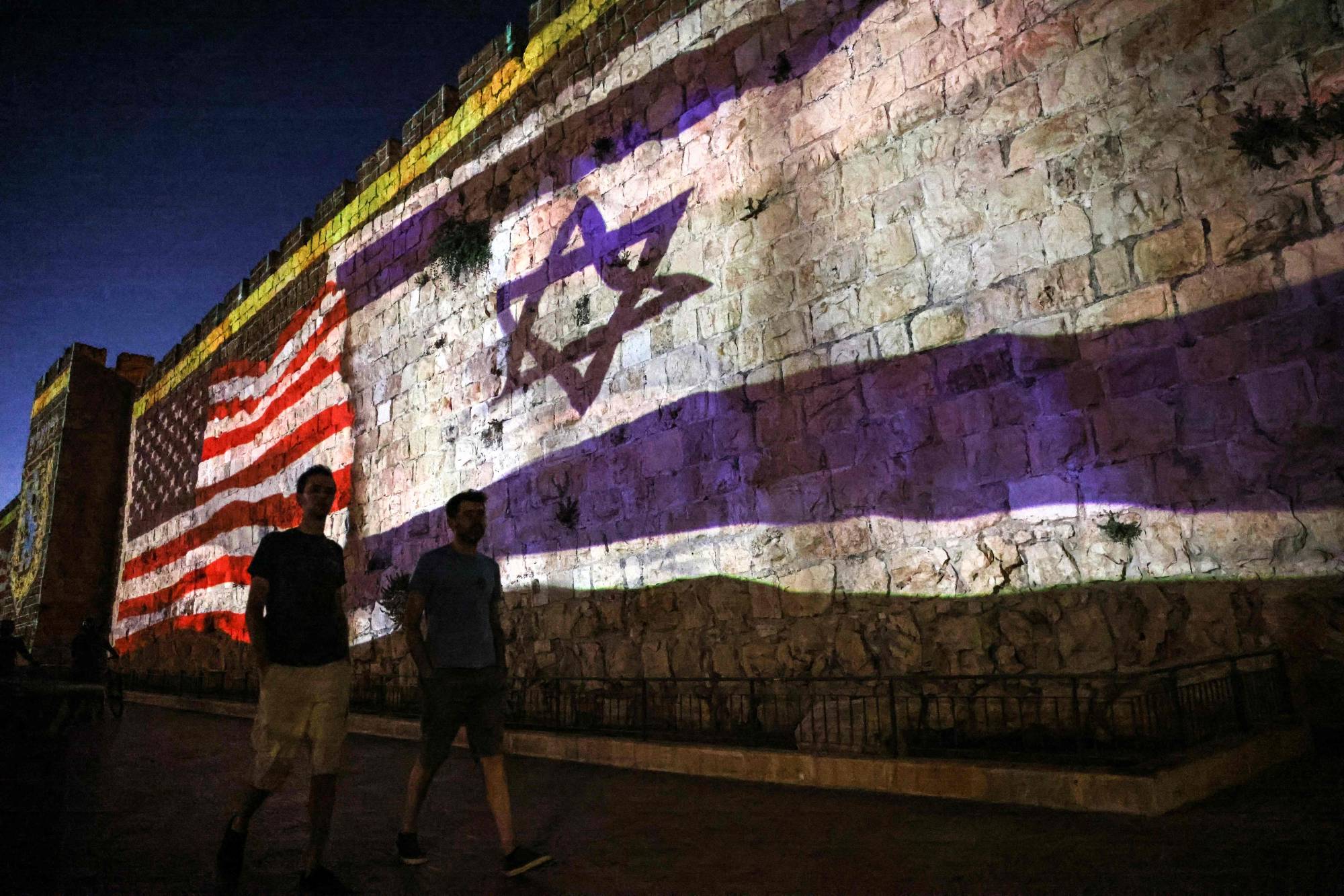 The Israeli and U.S. flags are projected against the wall of the old city of Jerusalem during the visit of the U.S. president on Wednesday. | AFP-JIJI