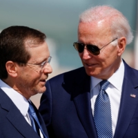 Israeli President Isaac Herzog and U.S. President Joe Biden participate in a welcoming ceremony at Ben Gurion International Airport in Lod, Israel, on Wednesday. | REUTERS
