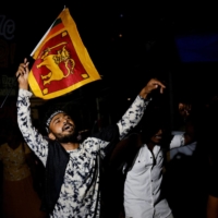 People dance as they celebrate the resignation of Sri Lanka’s President Gotabaya Rajapaksa at a protest site in Colombo, Sri Lanka, on Thursday. | REUTERS