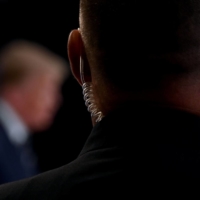 A Secret Service agent watches as then-U.S. President Donald Trump speaks during a news conference in Bedminster, New Jersey, in August 2020. | AFP-JIJI