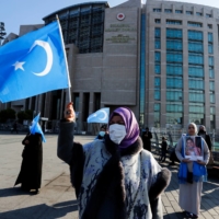 Ethnic Uyghur women take part in a protest against China in Istanbul in January.   | REUTERS 