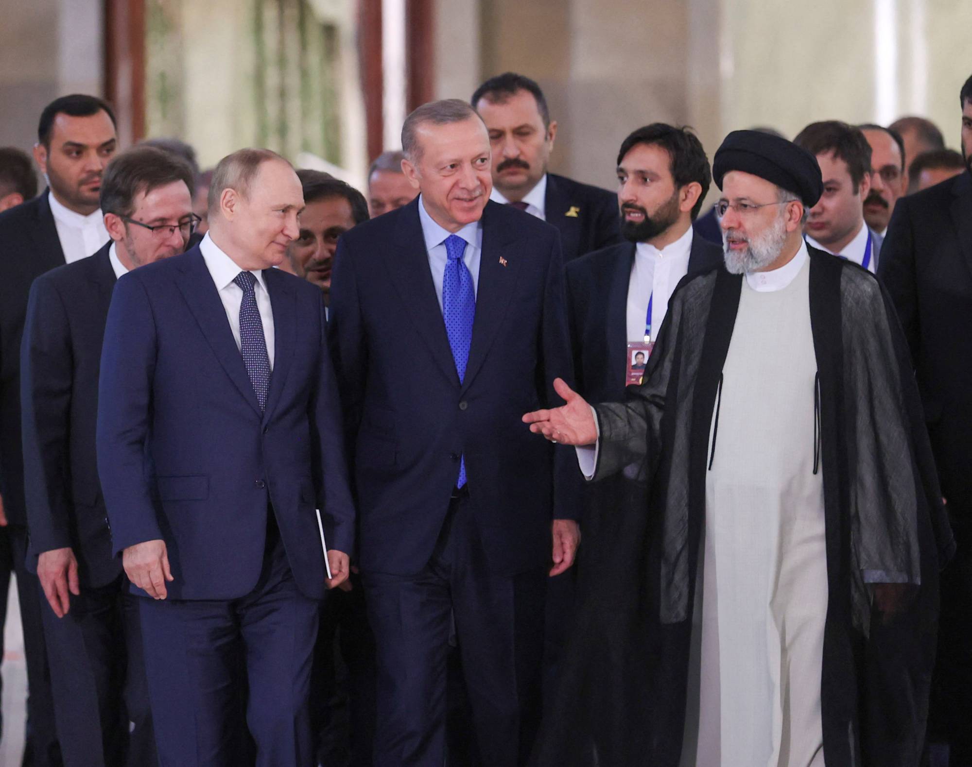 Russian President Vladimir Putin, Iranian President Ebrahim Raisi and Turkish leader Recep Tayyip Erdogan arrive for a news conference in Tehran on Tuesday. | Turkish Presidential Press Office / via REUTERS