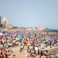 A crowd gathers at Brighton Beach in New York.  | YUVRAJ KHANNA / THE NEW YORK TIMES