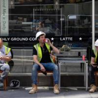 Workmen take a break outside a cafe during a heat wave in London. | BLOOMBERG