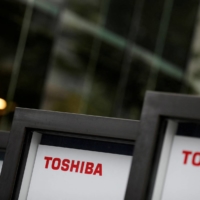 Toshiba has selected four bidders to proceed to a second bidding round in its buyout deal. | REUTERS