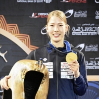 Misaki Emura poses with the gold medal after winning the individual women\'s sabre event at the world championships in Cairo on Wednesday. | KYODO