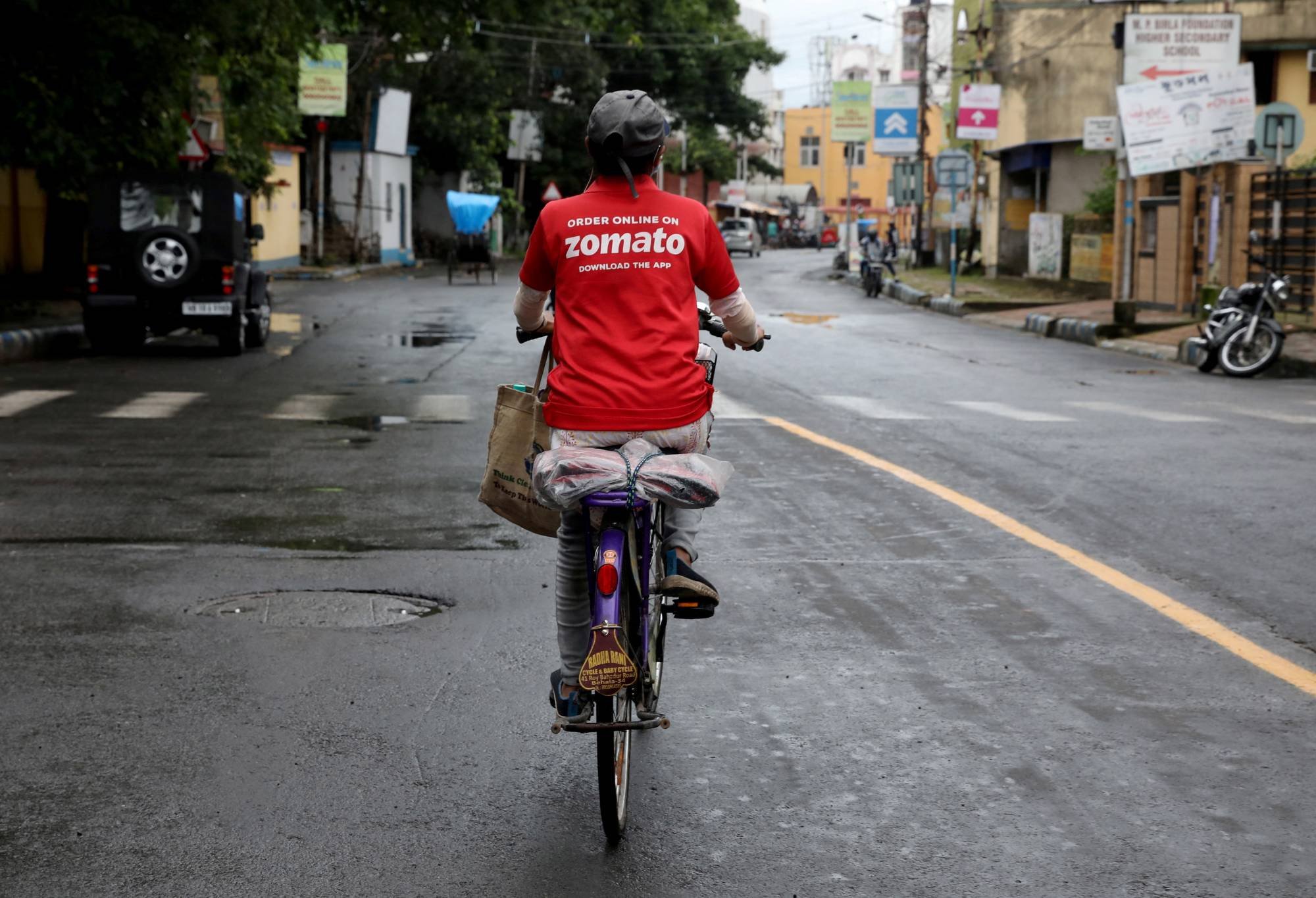 A Zomato delivery worker rides her bicycle along a road in Kolkata in July 2021. Demand for gig work has surged in recent years with the growth in e-commerce and the so-called 