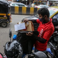 A Zomato delivery worker packs an order into a delivery bag in Mumbai, in July 2021. | BLOOMBERG