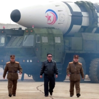 North Korean leader Kim Jong Un walks away from what state media said was a \"new type\" of intercontinental ballistic missile. Japan\'s defense white paper singled out nuclear-armed North Korea for its repeated missile launches — totaling a record 31 this year alone. | KCNA / VIA REUTERS