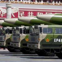 Military vehicles carrying DF-26 ballistic missiles in Beijing in September 2015. China has ramped up its military activities around the island, sending advanced fighters, bombers and cutting-edge warships and aircraft carriers into and over nearby waters. | REUTERS