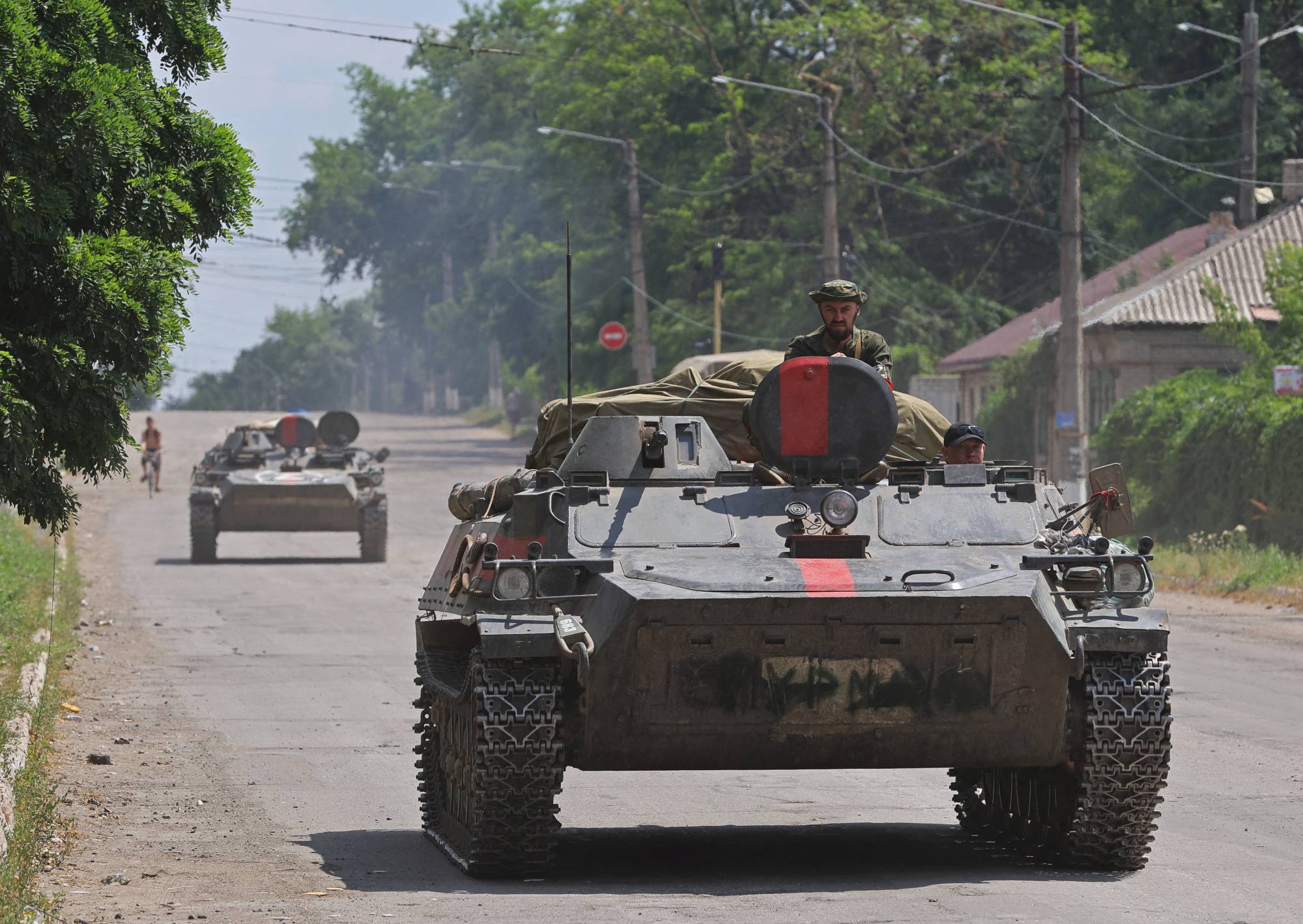 Pro-Russian forces ride an infantry fighting vehicle in the city of Lysychansk in Ukraine's Luhansk region on July 4. | REUTERS