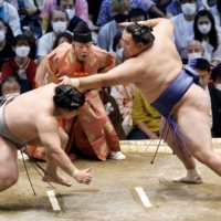 Tamawashi (right) pulled out of the Nagoya Grand Sumo Tournament due to a positive COVID-19 case in his stable. | KYODO