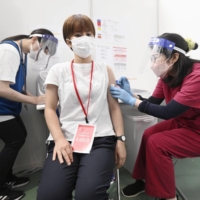 A nurse receives a fourth shot of a COVID-19 vaccine in Tokyo on Saturday.  | TOKYO METROPOLITAN GOVERNMENT / VIA KYODO 