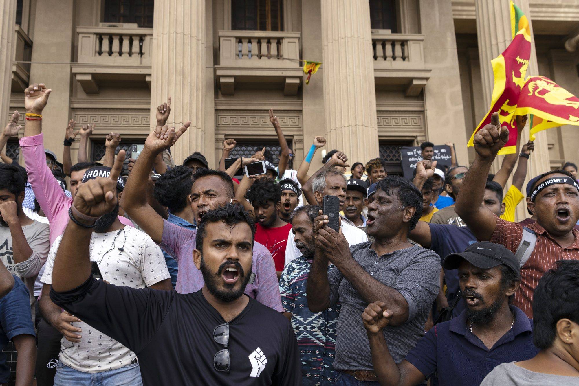 Demonstrators protest against the newly elected Sri Lanka President Ranil Wickremesinghe outside the president office in Colombo on Wednesday. The country's economy is in free fall and it is yet unclear when it will end. | BLOOMBERG