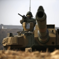A South Korean soldier in a K2 Black Panther tank takes up a position during a military exercise in Yangpyeong in 2015. Seoul has greatly boosted its defense exports in recent years. | REUTERS