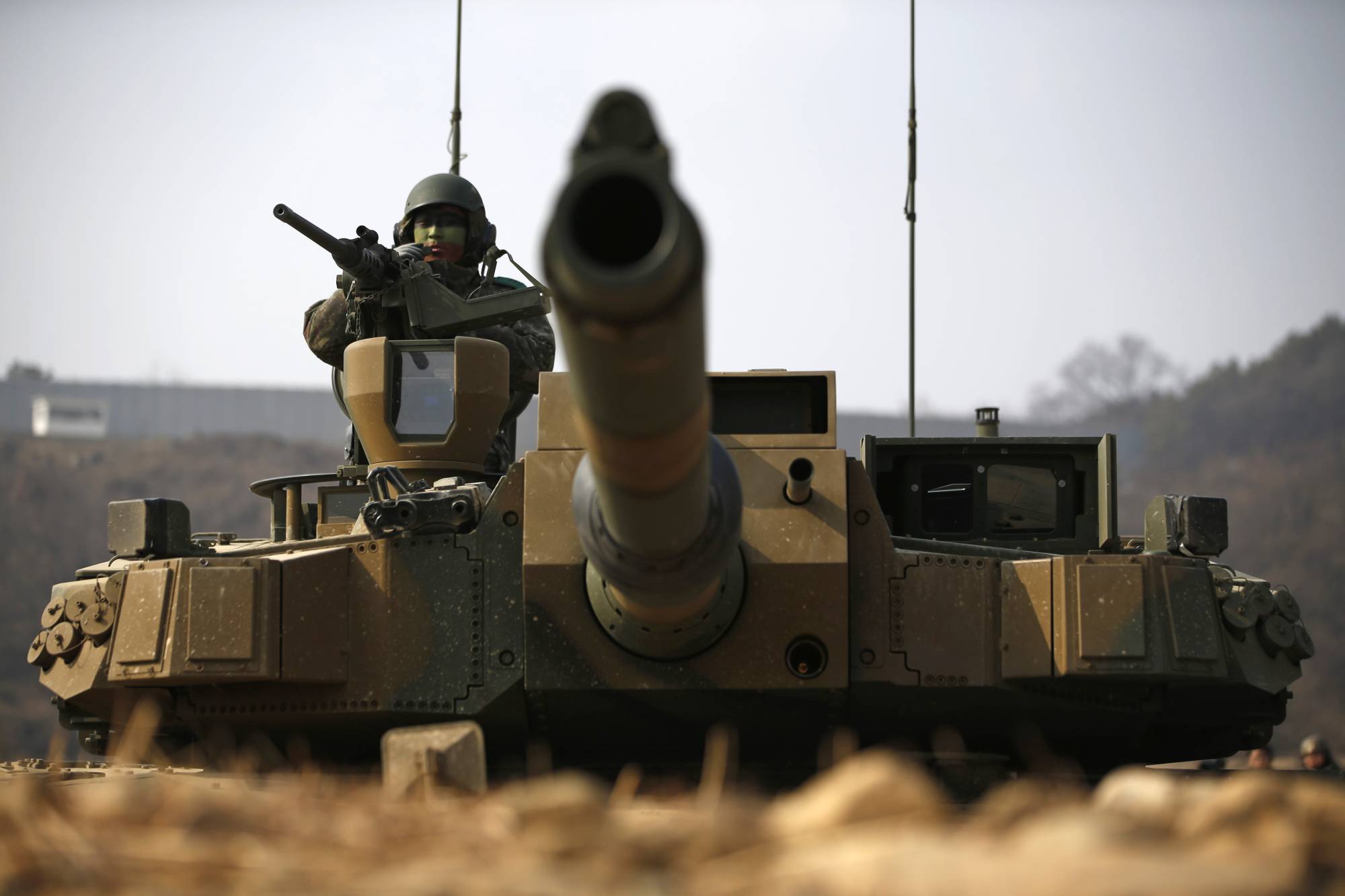 A South Korean soldier in a K2 Black Panther tank takes up a position during a military exercise in Yangpyeong in 2015. Seoul has greatly boosted its defense exports in recent years. | REUTERS