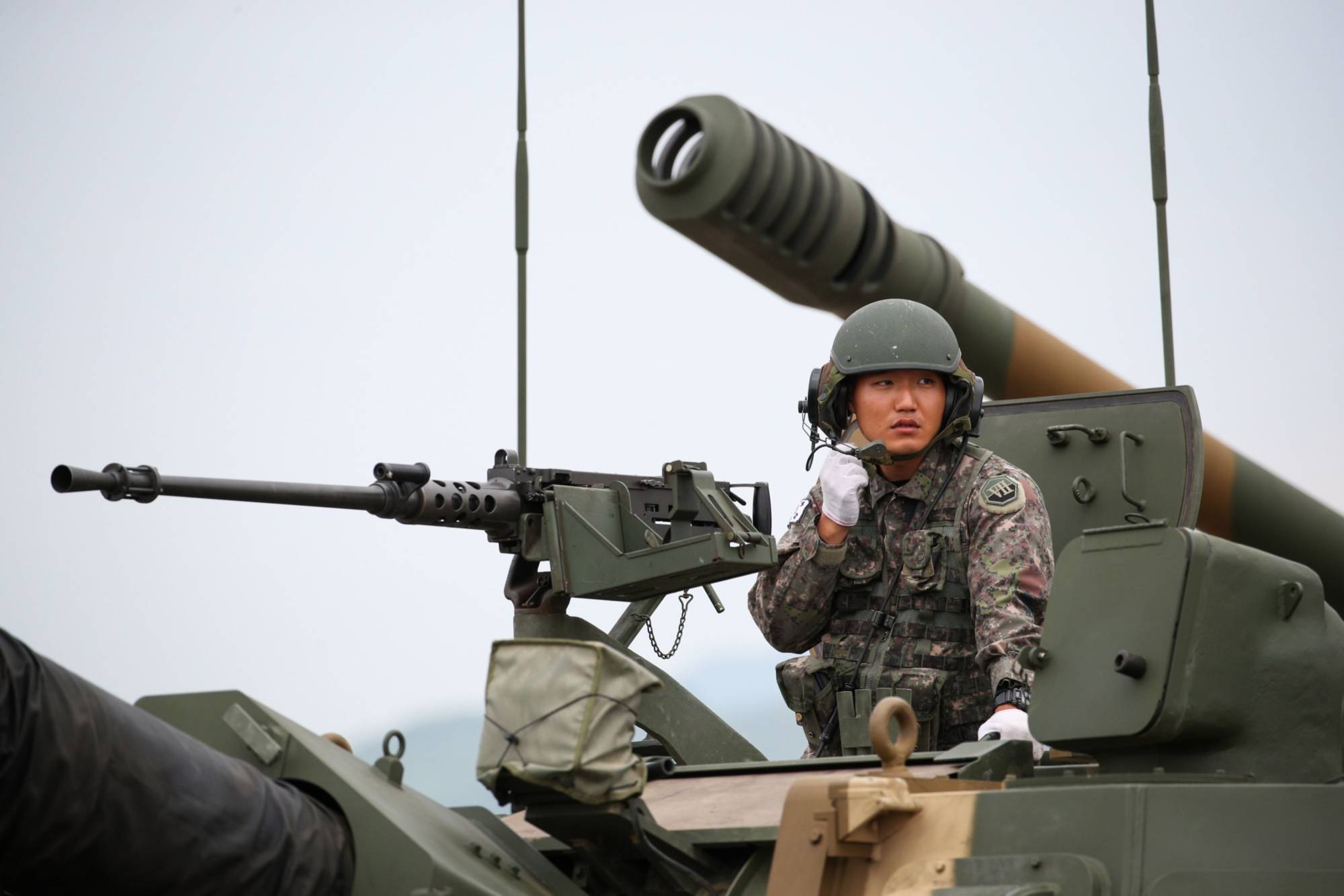 A South Korean soldier sits inside a K9 Thunder self-propelled howitzer at Daegu Air Base in Daegu, South Korea, in September 2019. | BLOOMBERG
