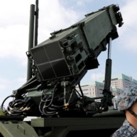 A Self-Defense Forces member stands in front of a Patriot Advanced Capability-3 missile unit at the Defense Ministry in Tokyo, on Oct. 8, 2017. | REUTERS