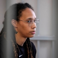 WNBA star Brittney Griner sits in a cage in a court room outside Moscow on Wednesday. | POOL / VIA REUTERS 