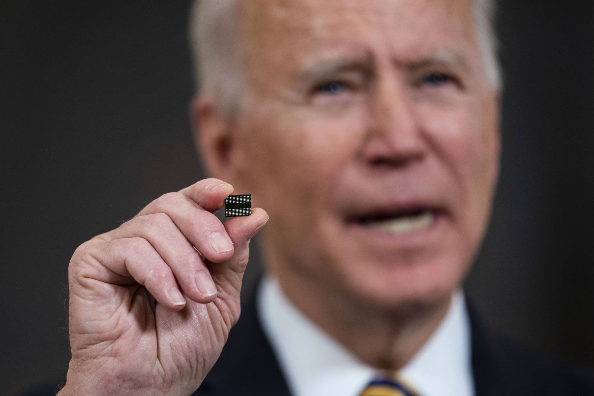 U.S. President Joe Biden displays a semiconductor before signing an executive order at the White House on Feb. 24, 2021. In the weeks before the House and the Senate ended 13 months of arguments and passed the $280 billion CHIPS and Science Act, China's main, state-supported chip maker cleared a major technological hurdle that delivered a bit of a shock to the world. | Doug Mills / The New York Times