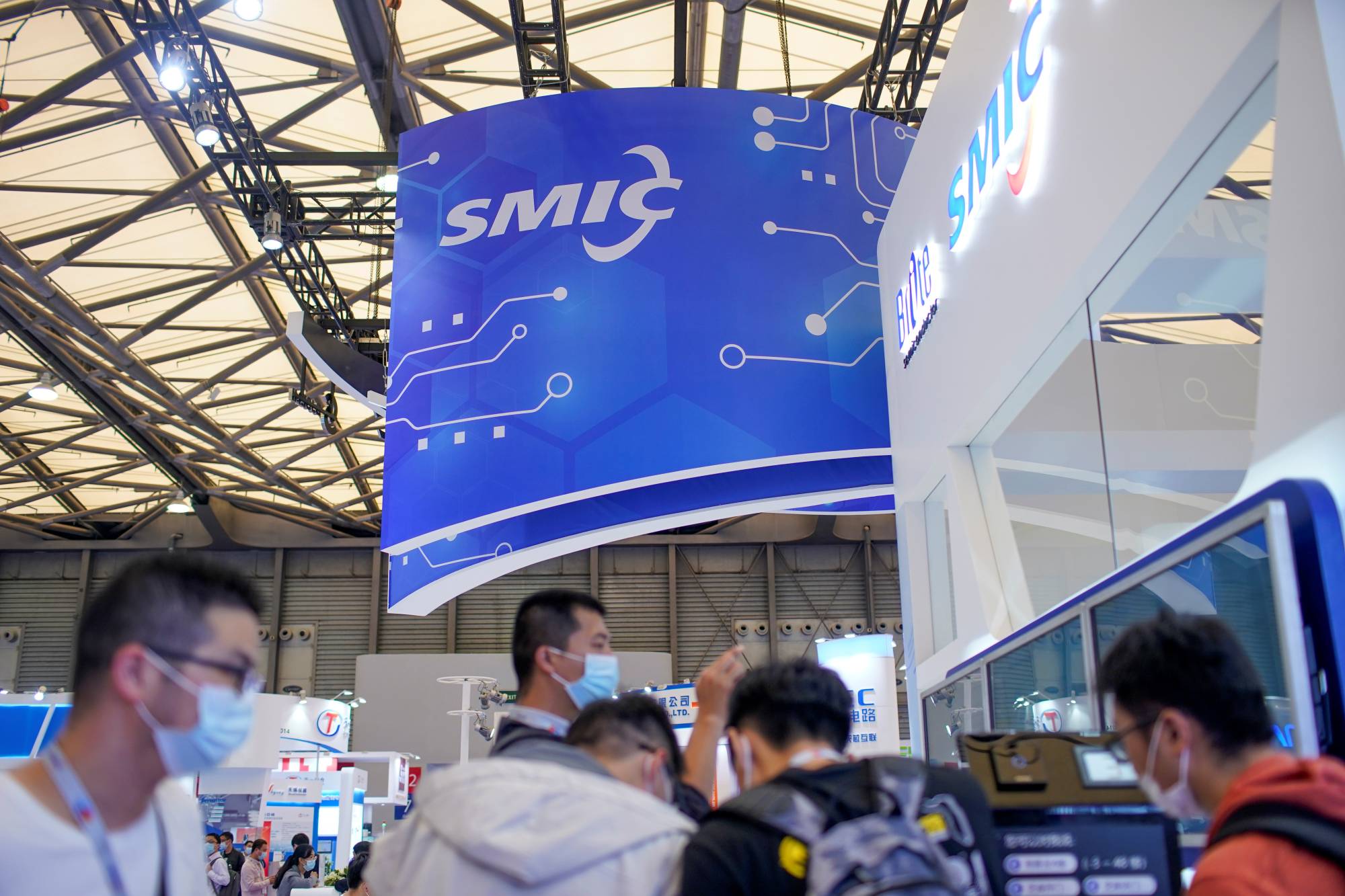 People visit a booth of Semiconductor Manufacturing International Corporation at China International Semiconductor Expo in Shanghai in October 2020. | Reuters