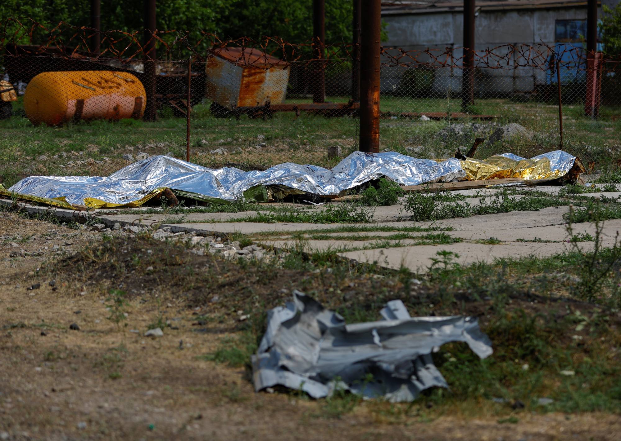  | SENSITIVE MATERIAL. THIS IMAGE MAY OFFEND OR DISTURB. Burnt bodies of detainees lie covered following the shelling at a pre-trial detention center in the course of Ukraine-Russia conflict, in the settlement of Olenivka in the Donetsk Region, Ukraine July 29, 2022. REUTERS/Alexander Ermochenko