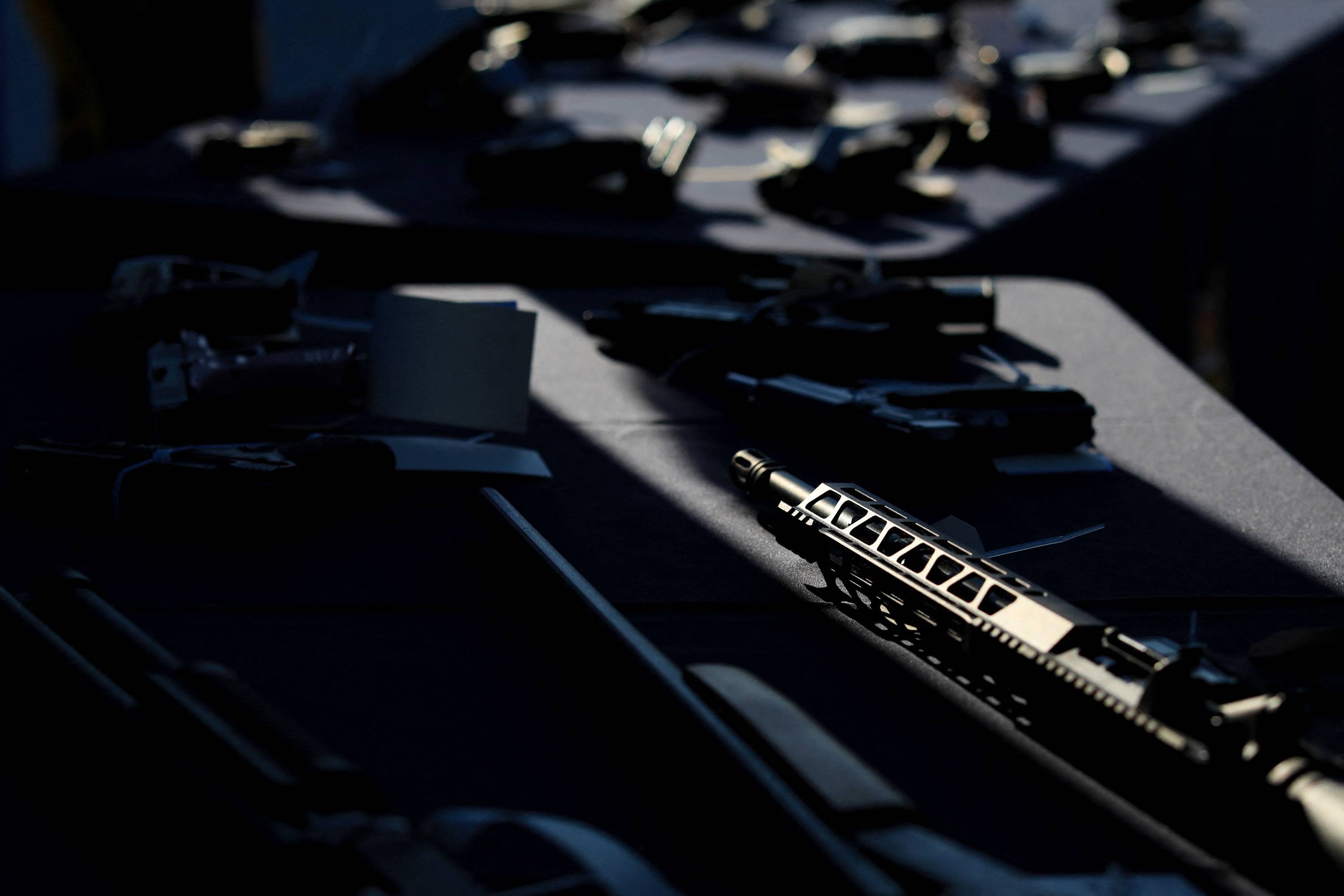 Firearms confiscated at the Windsor-Detroit border on display during a demonstration of technology that can scan truck trailers for compartments that could be used to hide guns, in Windsor, Ontario | Reuters