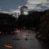 The floating lantern festival at Chidorigafuchi in Tokyo on Friday. Tokyo reported 33,466 new COVID-19 cases Saturday, up by from 32,698 a week earlier, along with 12 deaths.  | AFP-JIJI