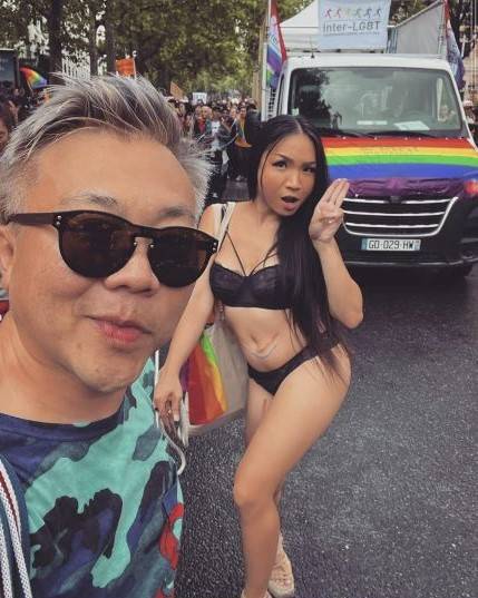 A photo posted on social media by Pavin Chachavalpongpun shows him posing with Aum Neko, who is holding up three fingers in protest against the Thai government, during an event in Paris in late June. | Nishinippon Shimbun