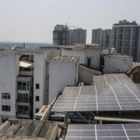 Solar panels on the roof of an apartment block in Bengaluru, India, in February. | BLOOMBERG