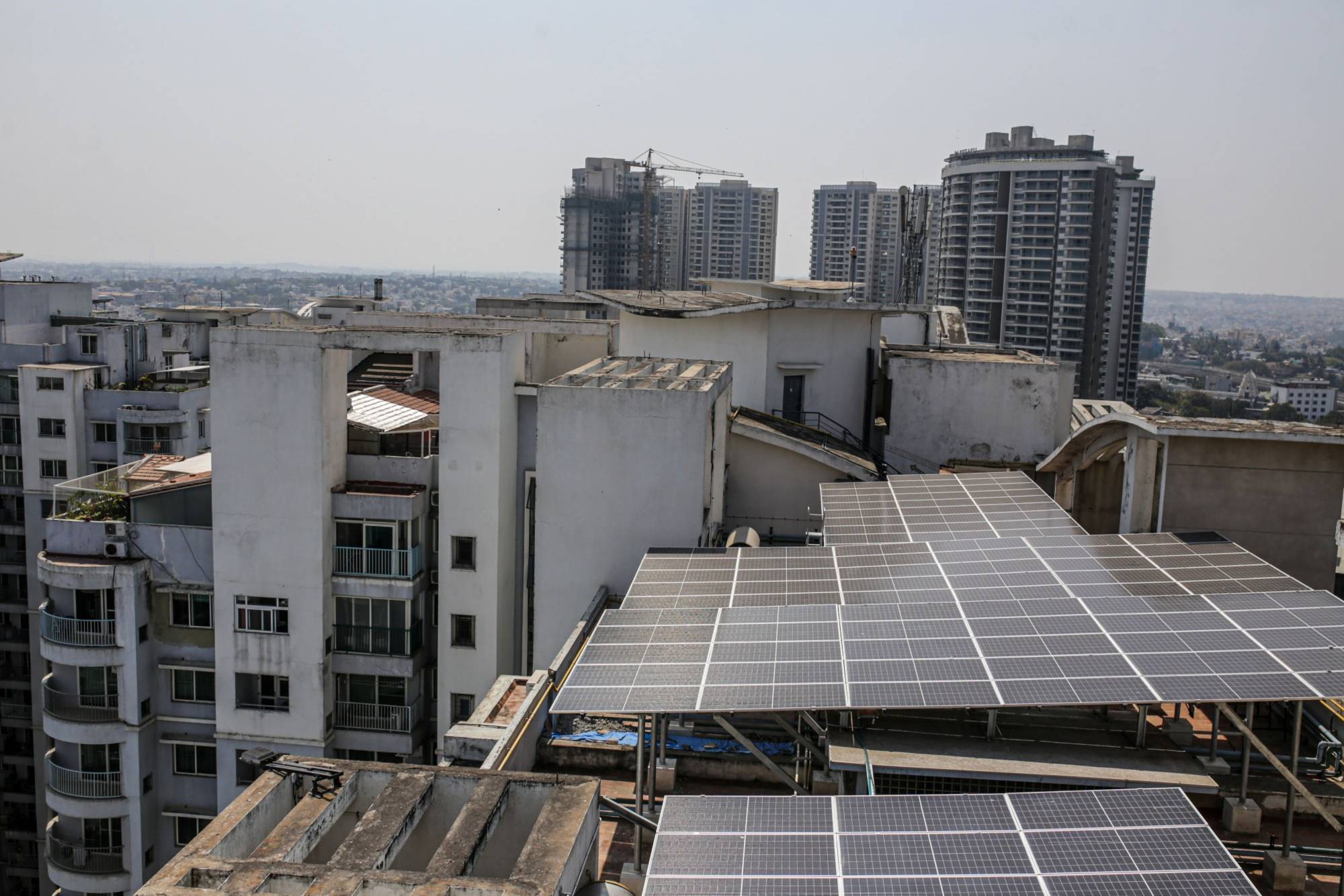 Solar panels on the roof of an apartment block in Bengaluru, India, in February. | Bloomberg
