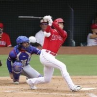 Shohei Ohtani hits a triple in the first inning against the Rangers in Anaheim, California, on Sunday. | KYODO