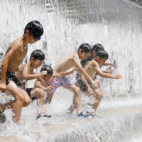 Children play at a park in Tokyo\'s Edogawa Ward the same day temperatures topped 30 degrees Celsius by 9 a.m. in 380 locations across the country. | KYODO 