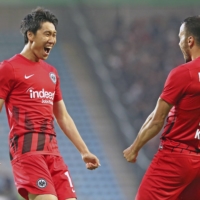 Frankfurt\'s Daichi Kamada (left) celebrates after scoring his team\'s opening goal in their German Cup match in Magdeburg, Germany, on Monday. | KYODO