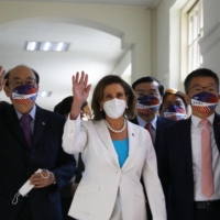 U.S. House Speaker Nancy Pelosi (center) arrives at the Legislative Yuan in Taipei on Wednesday. Pelosi’s visit is fanning fresh jitters among investors already spooked by the threat of a global slowdown amid surging inflation. | BLOOMBERG