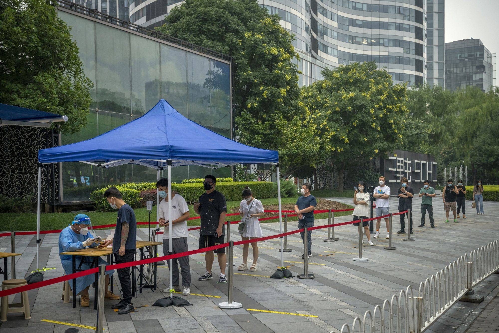 Residents line up at a COVID-19 testing booth in Beijing on July 27. As omicron subvariants become ever-more infectious, Xi’s resolve to avert virus fatalities is growing stronger — leading many experts to warn that COVID zero could continue well beyond 2022. | BLOOMBERG