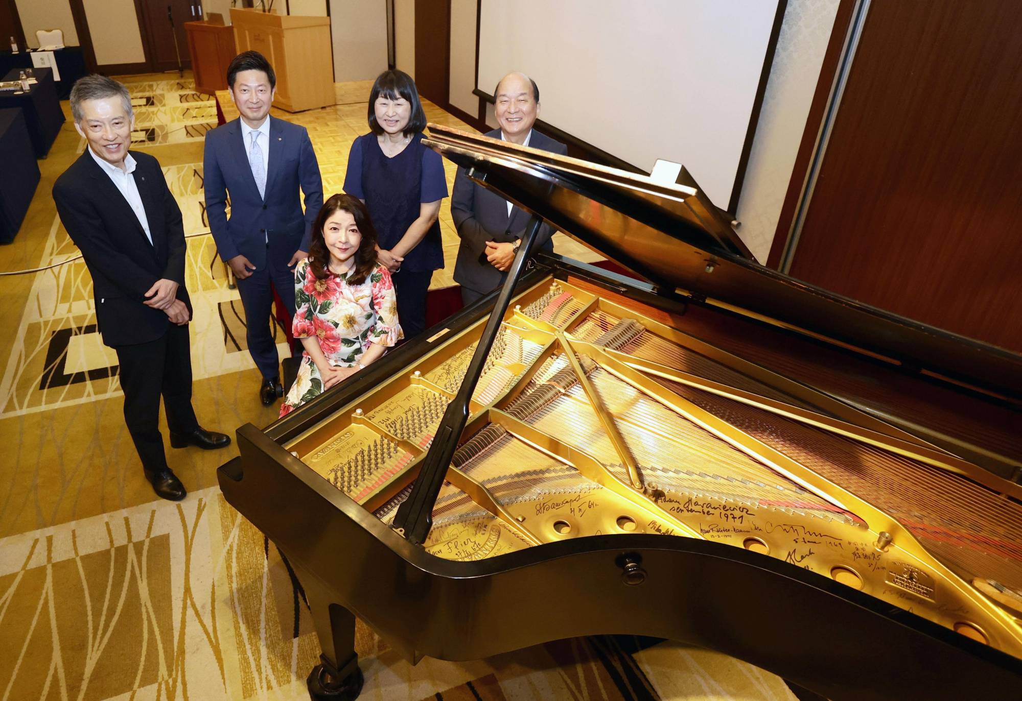 Members of the piano conservation project committee in Fukuoka on July 29 | NISHINIPPON SHIMBUN
