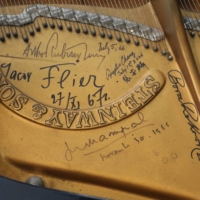 Autographs of renowned classical music performers including Arthur Rubinstein on a grand piano in Fukuoka | LEGACY PIANO CONSERVATION PROJECT COMMITTEE / VIA NISHINIPPON SHIMBUN
