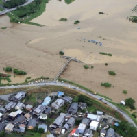 The Takatoki River overflowed in Nagahama, Shiga Prefecture, on Friday following heavy rain. | KYODO