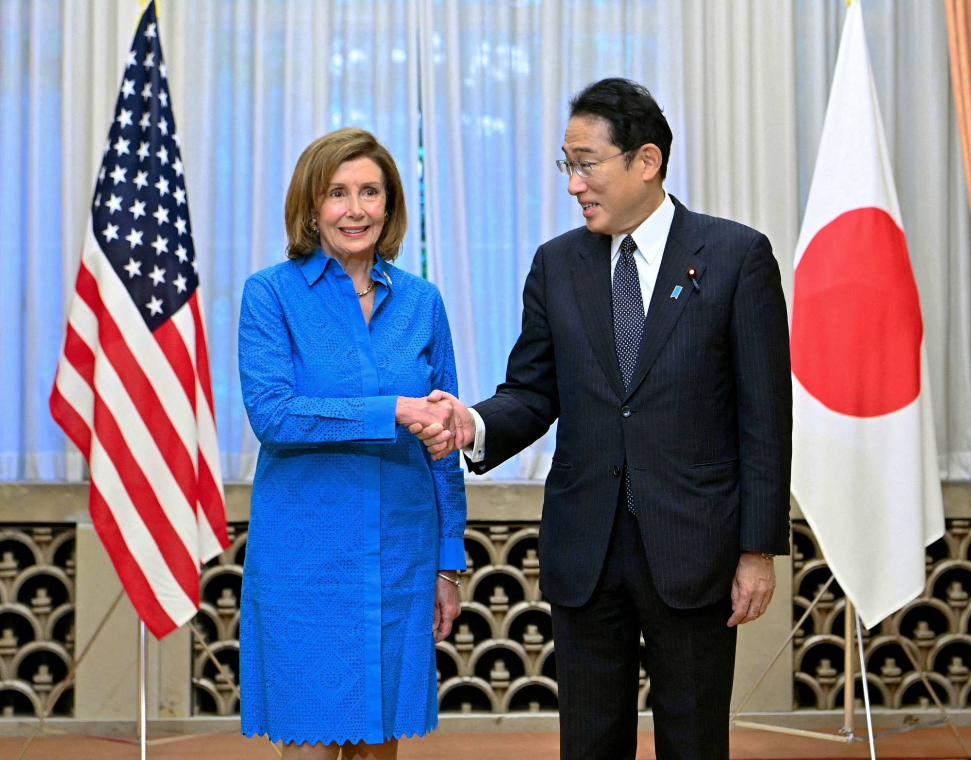 U.S. House of Representatives Speaker Nancy Pelosi shakes hands with Prime Minister Fumio Kishida before their meeting in Tokyo on Friday. | POOL / VIA KYODO