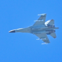 A Chinese military jet flies over Pingtan Island, one of mainland China\'s closest points to Taiwan, in Fujian province, on Friday.   | AFP-JIJI